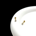 Macro detail of gold-plated surgical steel stud earrings with clear cubic zirconia stones - 3mm / Gold