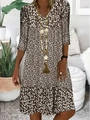 Detailed close-up of brown floral V-neck dress with long sleeves and delicate boho print - S / Tops / Brown