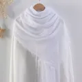 Solid white cotton linen scarf with frayed edges displayed on a rustic wall hook - Milky White