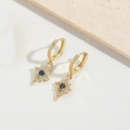 Detail of gold star earrings with blue zircon and pavé crystals on white texture - Blue Zirconia (ES2615-5)