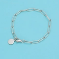 Detailed view of silver stainless steel paperclip chain bracelet with a round charm - 15CM / Steel