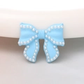 Detail of light blue resin bow charm with white pearl border for DIY jewelry making - Light Blue