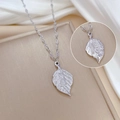 Macro detail of silver titanium steel leaf pendant with Chinese characters on silk - Silver (Wealthy Overnight)