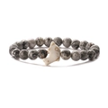 Macro shot of grey stone beaded elastic bracelet with a white dolphin accent bead - Map