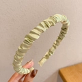 Close-up of light green pleated satin headband showing premium fabric texture - Pleated Satin Style / Green