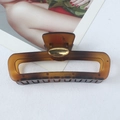 Large amber tortoiseshell hair claw clip with golden handmade plaque on white background - Yellow Stripes Oval Gold Label
