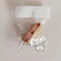 Peanut squeeze fidget toy with pink beans and keychain, light brown variant in packaging - OPP Bag Packaged Squeeze Peanut