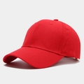 Close-up of a bright red cotton baseball cap with ventilation eyelets and curved brim - Adjustable / Red