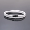 Detailed close-up of white braided couple bracelet with black magnetic clasp mechanism - Silver Gray