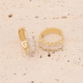 Detail of gold huggie earrings with micro-pave rectangular zircons on rock texture - White