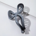 Detail shot of a matte gradient bow hair claw clip in grey and black on a white background - Gradient Glossy Gray