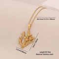 Golden coral branch pendant necklace in stainless steel on beige textured paper - Coral