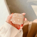 Close-up of luxury sparkling champagne gold rhinestones on AirPods case held in hand - Gold Rhinestone