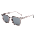 Stylish square frame sunglasses in transparent brown with grey lenses, 45-degree angle view - Champagne Black Grey Lens