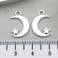 Silver alloy moon and star pendant charms shown with a ruler for size reference - One Star 11x17mm 0.5g 8519