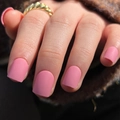 Short square matte pink press-on nails shown on hand with a warm knit background - Glue Type / Matte Pink (JP3178)