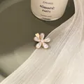 Elegant gold flower hair clip with pearl petals on a vintage green jewelry tray - Single Pearl Flower Small
