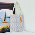 Close-up of pink and blue geometric knit tote bag with detailed diamond patterns - Diamond Grid Light Pink