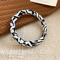 Detailed view of fashionable zebra pattern leather wrap bracelet on woven background - Black and White Zebra Round Style / Black