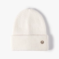 White winter knit beanie featuring a fuzzy texture and decorative metal M logo emblem - One Size / Cream