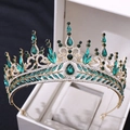 Close-up of luxury gold crown with emerald green crystals and rhinestones in a gift box - Gold with Green Rhinestones
