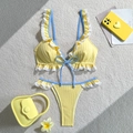 Detailed flat lay of a ribbed yellow bikini featuring white lace trim and blue bow accents - S / Yellow