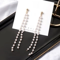 Elegant gold drop earrings with multiple white pearl tassels on a jewelry card display - E1853-Gold Long Tassel Beaded Drop