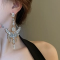 Close-up of extra-long silver tassel earrings with crystals and pearls on model - Vintage Ornate Extra Long Rhinestone Tassel Clip-on Earrings (Silver)
