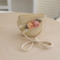 Close-up of children's straw crossbody bag with lace ribbon and fabric flower decor - Bag-Beige