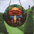 Round stained glass suncatcher featuring orange forest mushroom design with metal chain - Mushroom