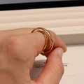 Macro detail of layered gold-tone double-band ring with a smooth minimalist finish - Adjustable Open / Gold