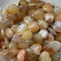 Bulk display of 2cm natural heart-shaped agate stones in assorted earthy tones - Natural Red Agate