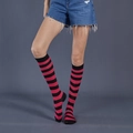 Pink and black striped knee-high socks with ribbed cuffs on model, cotton blend fabric - One Size / Rose Red and Black Wide Stripes