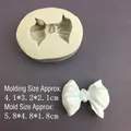 Silicone bow tie mold for DIY fondant and resin with a finished white sample shown - 3D Small Bowknot Mold - Grey