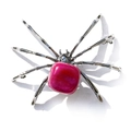 Macro detail of silver spider ornament featuring a large pink square crystal gemstone - Irregular Rose Red Agate