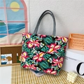 Canvas tote bag with tropical floral print and grey handles on a checkered cloth - Red Flower