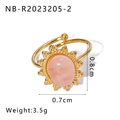 Detail shot of golden adjustable ring with pink oval stone and sunburst metal decor - Sunflower Pink Gemstone Style (NB-R2023205-2)