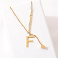 Golden titanium steel necklace with letter F pendant and cube charm on white background - Gold Initial F (8847)