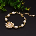 Baroque natural pearl bracelet with a golden floral bead charm and adjustable lobster clasp - Sunflower Bracelet