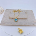Gold turtle necklace with blue enamel shell and crystals on a textured stone base - Blue & White Enamel Turtle