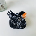 Detail of black swan hair claw clip with marble texture and rhinestone wing accents - New Pearl Black Swan