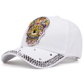 Close-up of white cotton baseball cap featuring colorful sugar skull embroidery and rivets - Adjustable / White