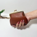 Mini vintage dark brown leather coin purse with golden clasp held in hand - Dark Brown