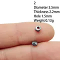 Macro detail of 3.5mm silver alloy bead spacer held on finger for size reference - 2#