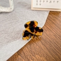 Mini tortoiseshell acetate hair claw clip for side bangs styling on a wooden table - Coffee Tortoise Shell