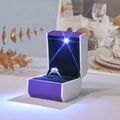 Macro shot of purple LED jewelry box with black velvet lining and starry light effect - Ring Box / Purple