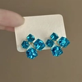 Detailed macro view of geometric blue multifaceted crystal stud earrings on white card - Blue Square Crystal Style (36#)