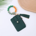 Detail of dark green pebbled leather card wallet with colorful silicone bead wristlet - Green