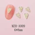 Detail of 6x8mm gold heart nail art charm with textured surface on pink background - Dotted Texture Heart (A009) / 10 Pieces Pack / Gold