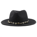 Close-up of black straw cowboy hat featuring cowrie shells and woven fedora texture - Black